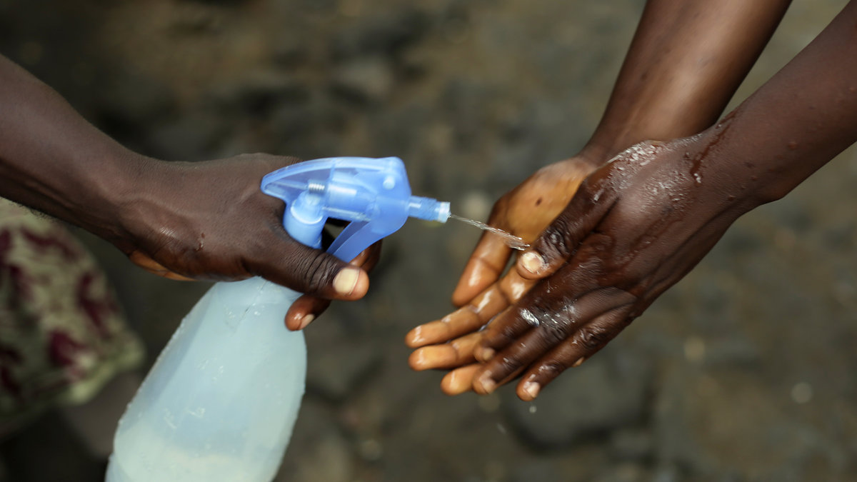 Promise Cooper, 16, tvättar händerna med klorinlösning på barnhemmet där han tillsammans med sin elvaårige bror nu bor. Deras föräldrar och fem månader gamla lillebror har under året dött i ebola. 